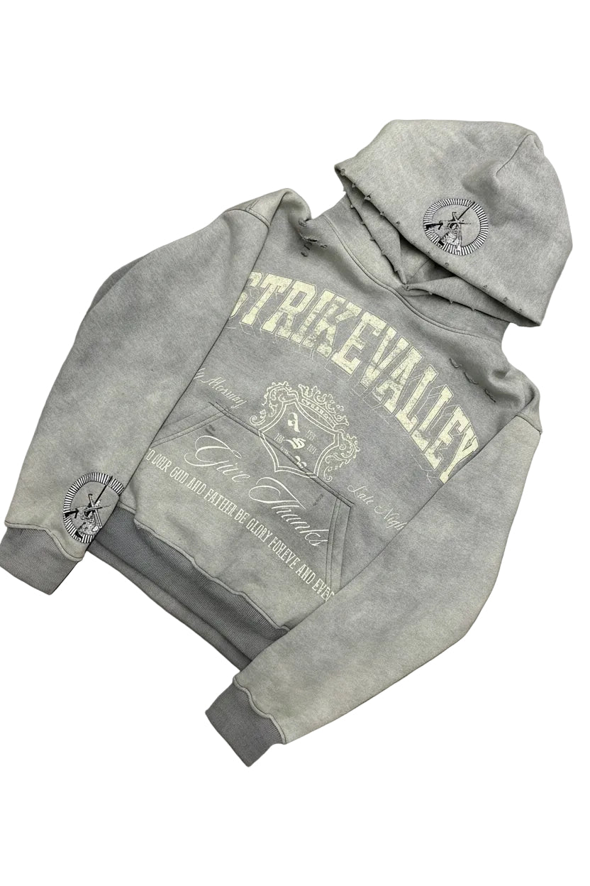 Gray hoodie with branding on a gray surface