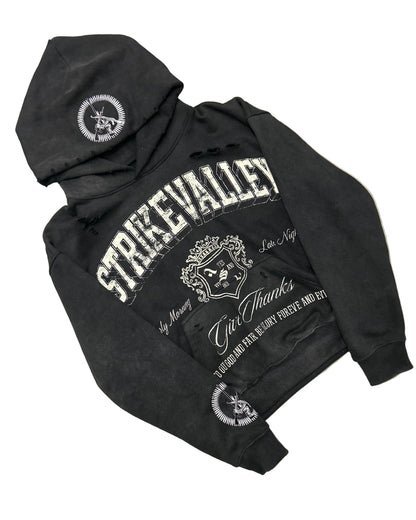 Black hoodie with white text and logos on a gray floor